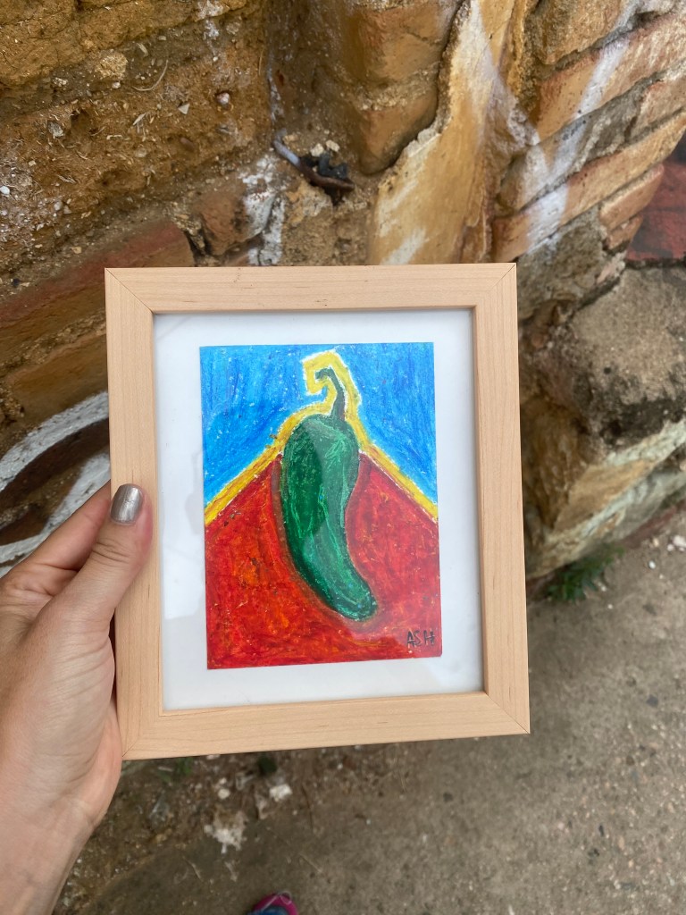 Bold pastel drawing of framed artwork of a chile serrano hung in the streets of Oaxaca City. This was left behind as a part of the experimental installation and performance of free art.